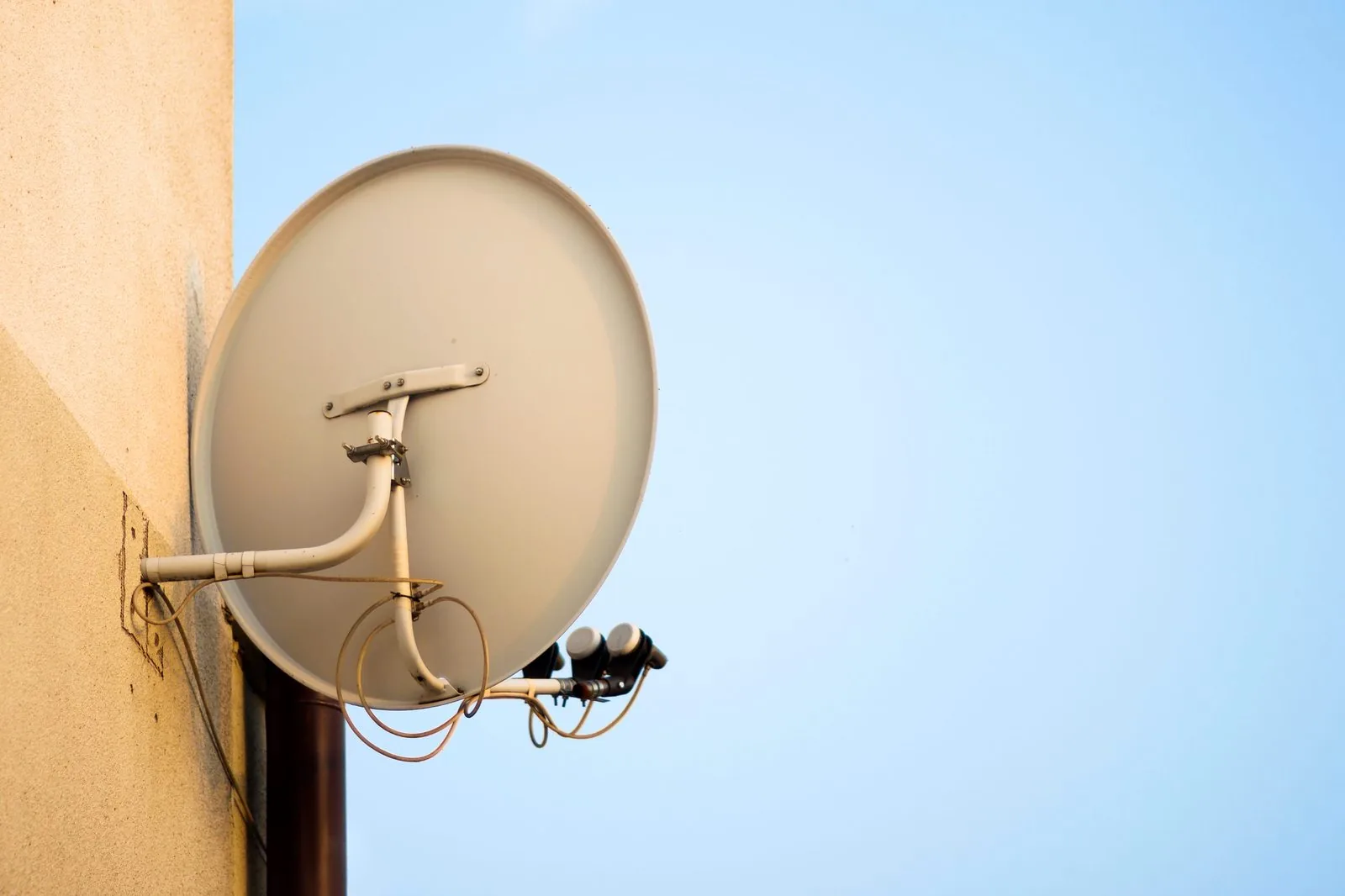 Satellite dish neatly mounted on the wall of a family home